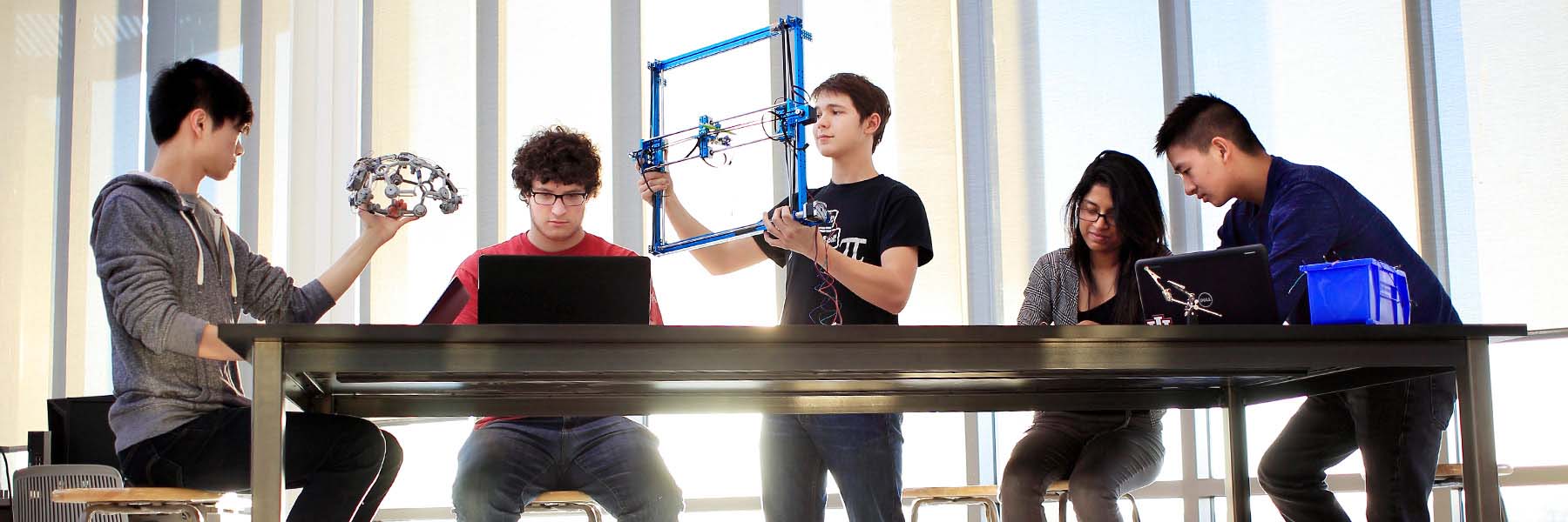 A group of students works together to construct an engineering project in the Fab Lab in Luddy Hall. 